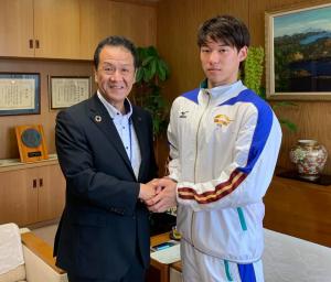 市長と黒川選手が握手をしている写真